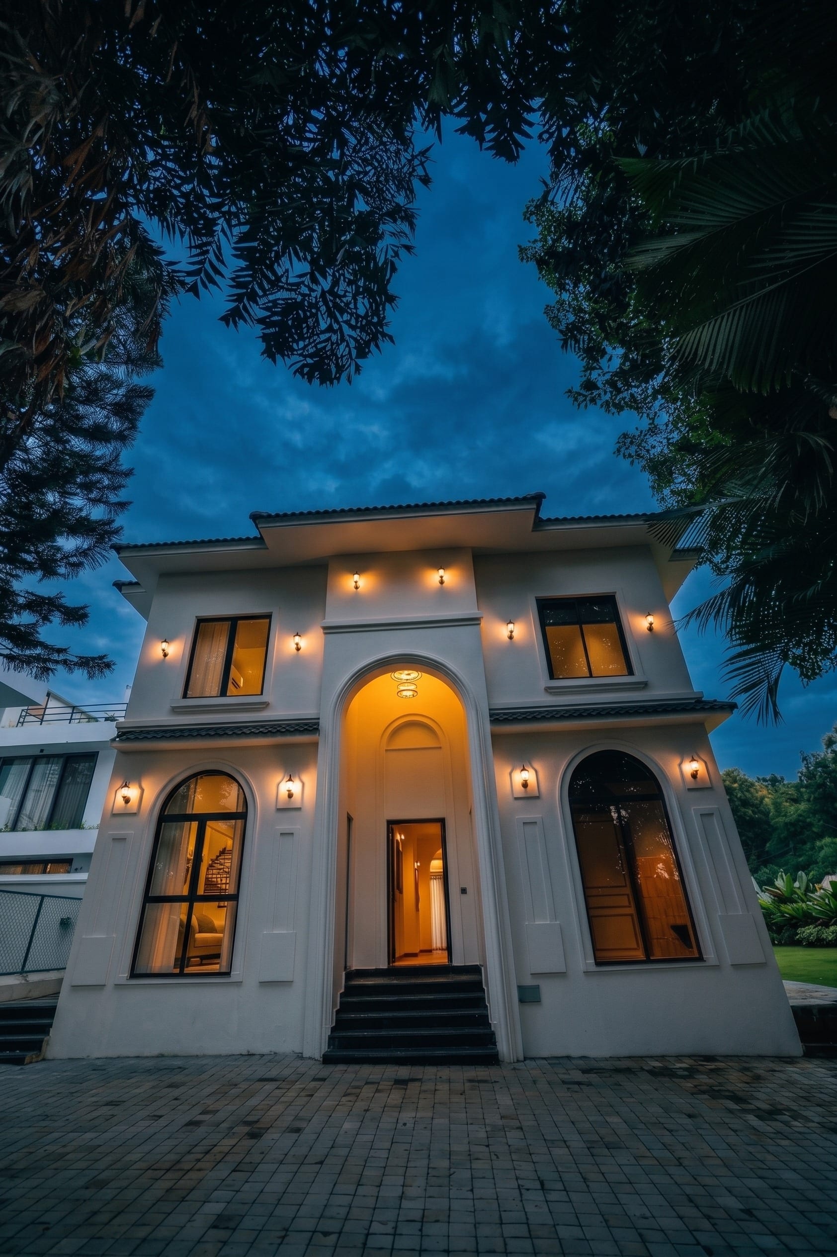 Casa Do Rei at blue hour, its arched entrance lit, Assagao, North Goa